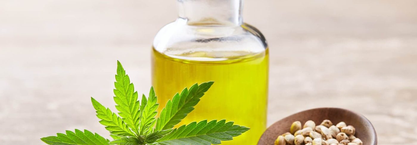 hemp-oil-with-seeds-and-cannabis-plant-on-wooden-b-95CVEKZ-2-e1635946228228